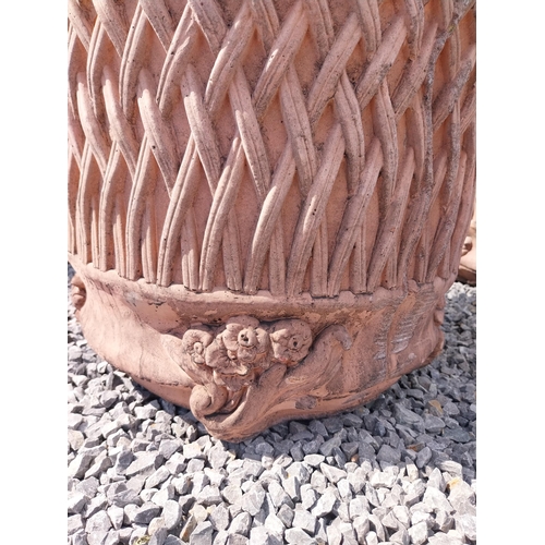 174 - Pair of moulded terracotta circular lattice urns {53 cm H x 54 cm Dia.}.