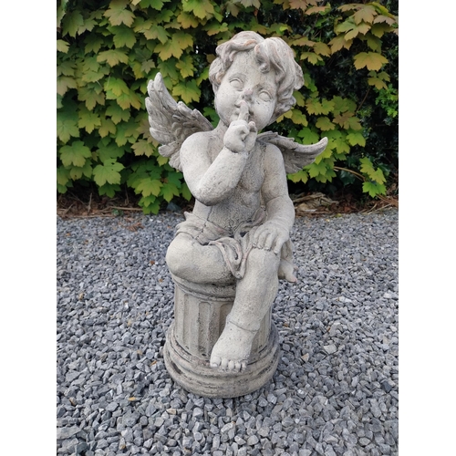 184 - Moulded stone figure of a winged Cherub {58 cm H x 31 cm W x 23 cm D}.