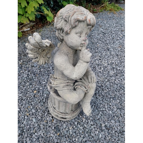 184 - Moulded stone figure of a winged Cherub {58 cm H x 31 cm W x 23 cm D}.