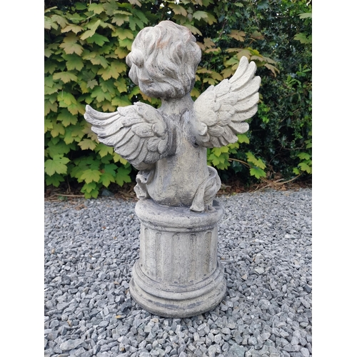 184 - Moulded stone figure of a winged Cherub {58 cm H x 31 cm W x 23 cm D}.