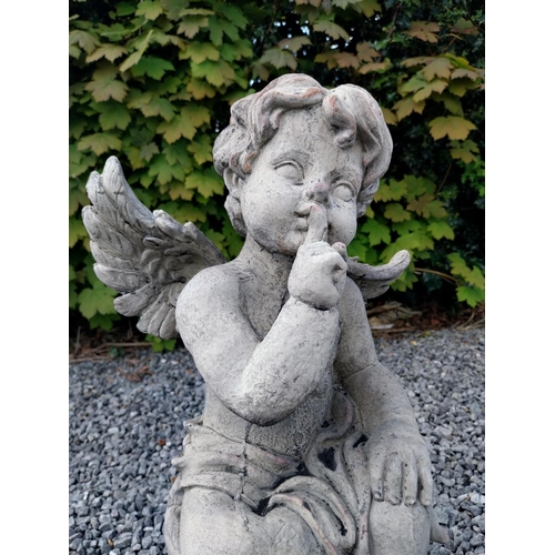 184 - Moulded stone figure of a winged Cherub {58 cm H x 31 cm W x 23 cm D}.