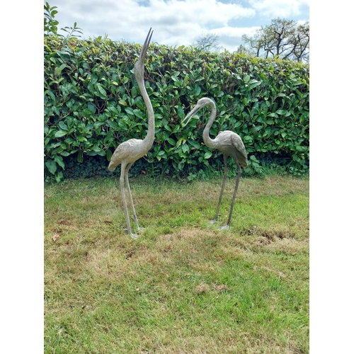 186 - Two bronze statues of Storks {120 cm H x 18 cm W x 53 cm D and 89 cm H x 18 cm W x 56 cm D}.