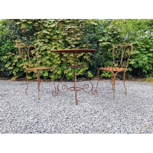 205 - Wrought iron caf� - garden circular table with two matching chairs {Tbl. 75 cm H x 70 cm Dia. Chairs... 