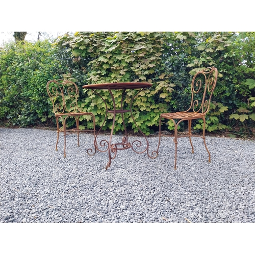 205 - Wrought iron caf� - garden circular table with two matching chairs {Tbl. 75 cm H x 70 cm Dia. Chairs... 