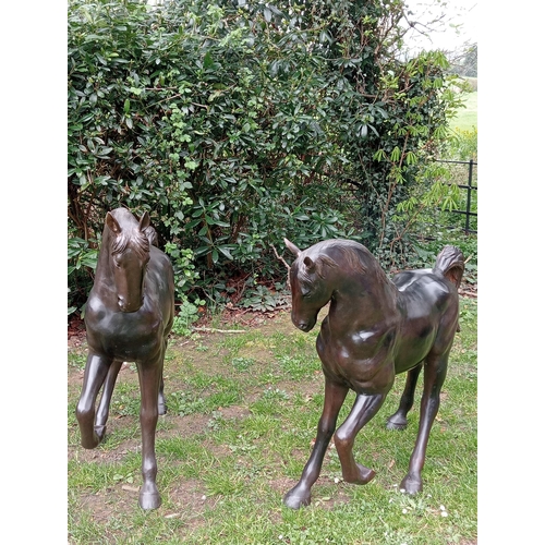 253 - Pair of bronze statues of foals {H 100cm x W 120cm x D 30cm}. (NOT AVAILABLE TO VIEW IN PERSON)