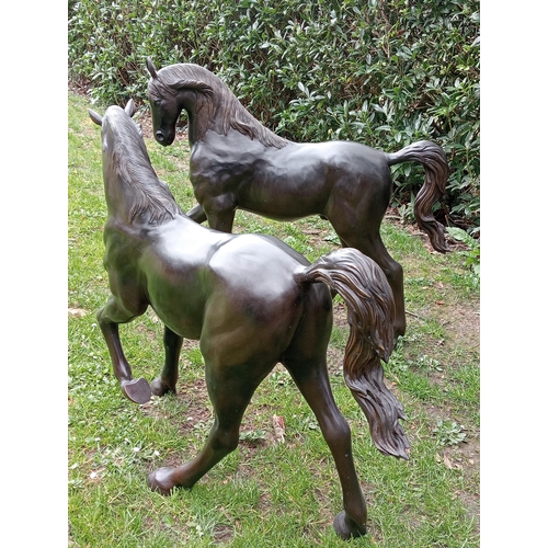 253 - Pair of bronze statues of foals {H 100cm x W 120cm x D 30cm}. (NOT AVAILABLE TO VIEW IN PERSON)