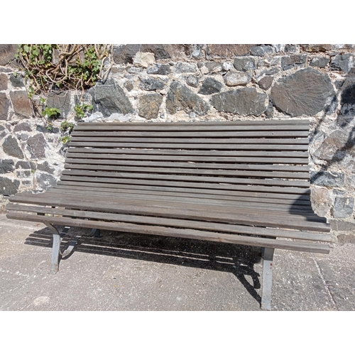 357 - Wrought iron and  wooden rolltop garden bench {H 80cm x D 72cm x W }.