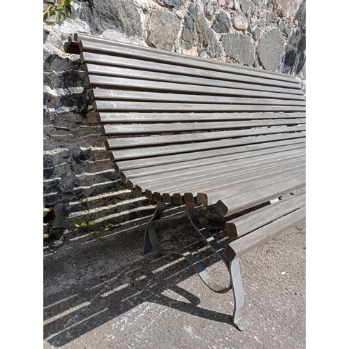 357 - Wrought iron and  wooden rolltop garden bench {H 80cm x D 72cm x W }.