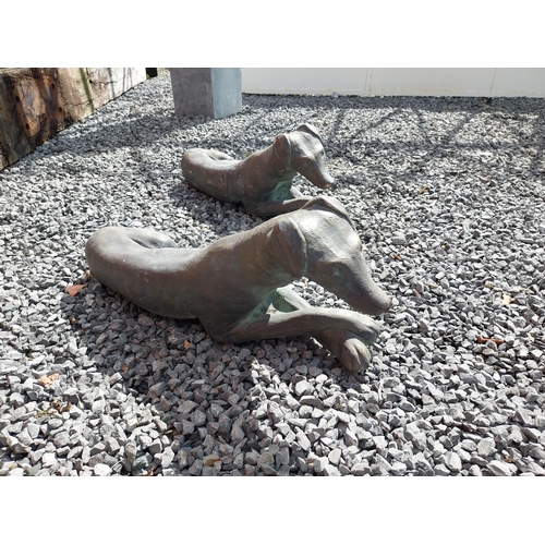 394 - Pair of painted moulded terracotta statues of recumbent Whippets {24 cm H x 60 cm W x 19 cm D}.