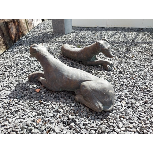 394 - Pair of painted moulded terracotta statues of recumbent Whippets {24 cm H x 60 cm W x 19 cm D}.