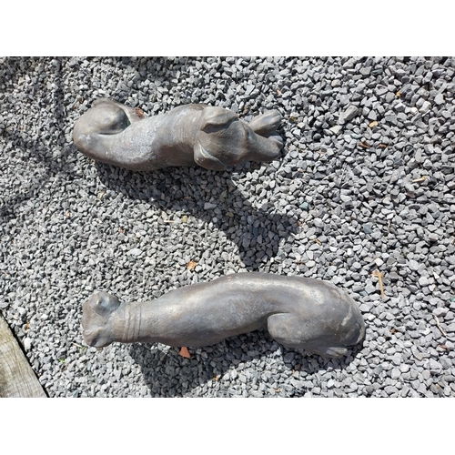 394 - Pair of painted moulded terracotta statues of recumbent Whippets {24 cm H x 60 cm W x 19 cm D}.