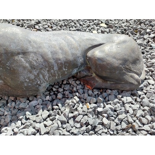 394 - Pair of painted moulded terracotta statues of recumbent Whippets {24 cm H x 60 cm W x 19 cm D}.