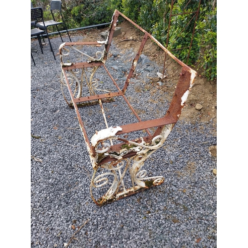 398 - Wrought iron garden bench - in need of restoration {95 cm H x 120 cm W x 58 cm D}.