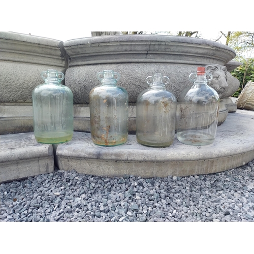 414 - Collection of four glass demijohns {36 cm H x 16 cm Dia.}.