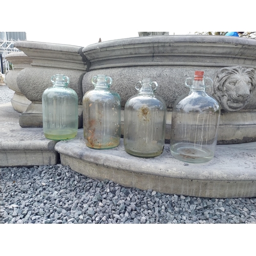 414 - Collection of four glass demijohns {36 cm H x 16 cm Dia.}.