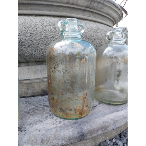 414 - Collection of four glass demijohns {36 cm H x 16 cm Dia.}.