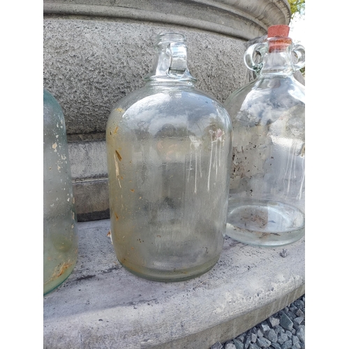 414 - Collection of four glass demijohns {36 cm H x 16 cm Dia.}.