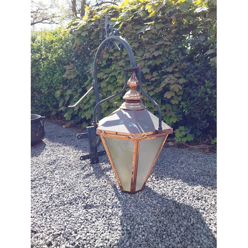 524 - Good quality copper wall lantern with wrought iron bracket {129 cm H x 94 cm W x 54 cm D}.