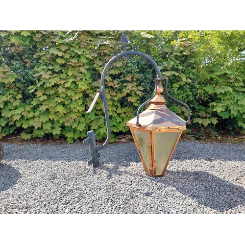 524 - Good quality copper wall lantern with wrought iron bracket {129 cm H x 94 cm W x 54 cm D}.