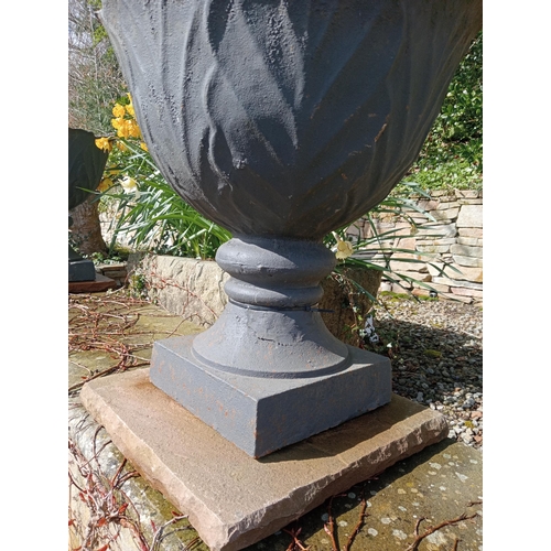 529 - Pair of cast iron urns raised on sandstone pedestal {H 67cm x Dia 60cm }. (NOT AVAILABLE TO VIEW IN ... 