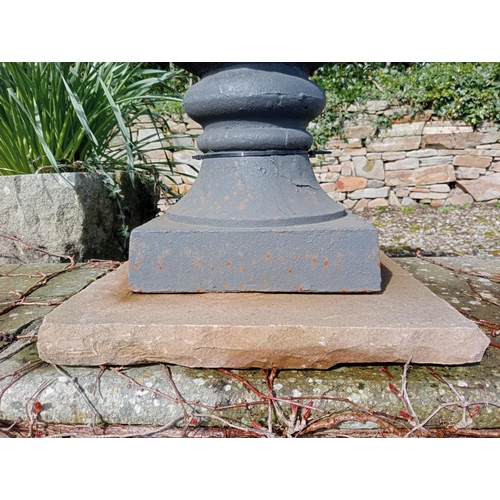 529 - Pair of cast iron urns raised on sandstone pedestal {H 67cm x Dia 60cm }. (NOT AVAILABLE TO VIEW IN ... 