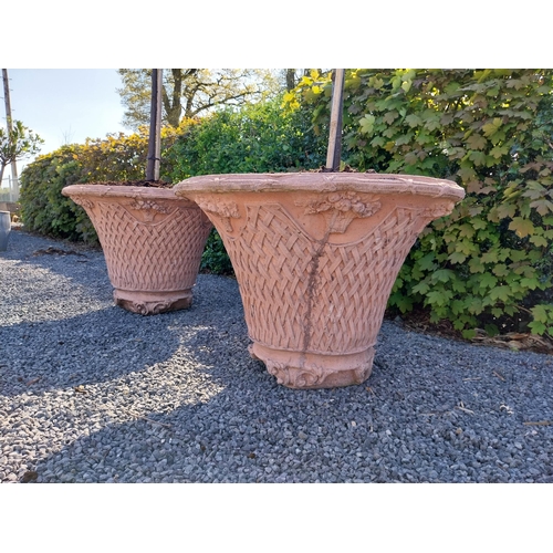 532 - Pair of moulded terracotta lattice urns with tree {Urn dimension 77 cm H x 105 cm Dia.}.