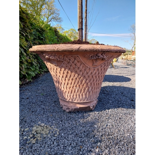 532 - Pair of moulded terracotta lattice urns with tree {Urn dimension 77 cm H x 105 cm Dia.}.