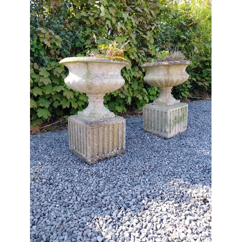 542 - Pair of early 20th C. composition urns on square pedestals {68 cm H x 46 cm Dia.}.