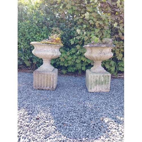 542 - Pair of early 20th C. composition urns on square pedestals {68 cm H x 46 cm Dia.}.