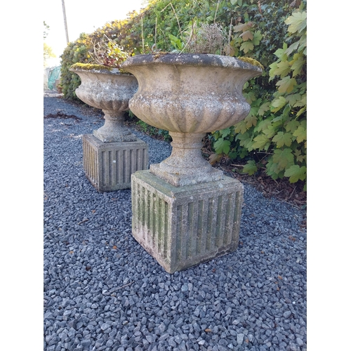 542 - Pair of early 20th C. composition urns on square pedestals {68 cm H x 46 cm Dia.}.