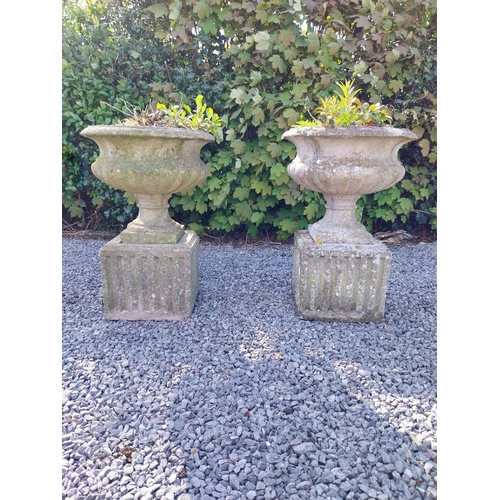 543 - Pair of early 20th C. composition urns on square pedestals {68 cm H x 46 cm Dia.}.