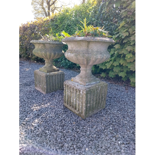 543 - Pair of early 20th C. composition urns on square pedestals {68 cm H x 46 cm Dia.}.