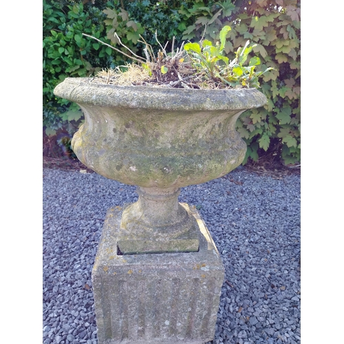 543 - Pair of early 20th C. composition urns on square pedestals {68 cm H x 46 cm Dia.}.