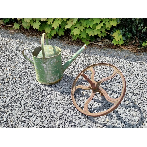 544 - Metal watering can and cast iron wheel barrow wheel {39 cm H x 49 cm W x 26 cm D and 36 cm W x 39 cm... 