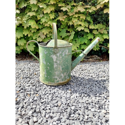 544 - Metal watering can and cast iron wheel barrow wheel {39 cm H x 49 cm W x 26 cm D and 36 cm W x 39 cm... 