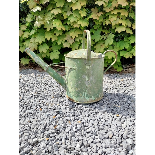 544 - Metal watering can and cast iron wheel barrow wheel {39 cm H x 49 cm W x 26 cm D and 36 cm W x 39 cm... 