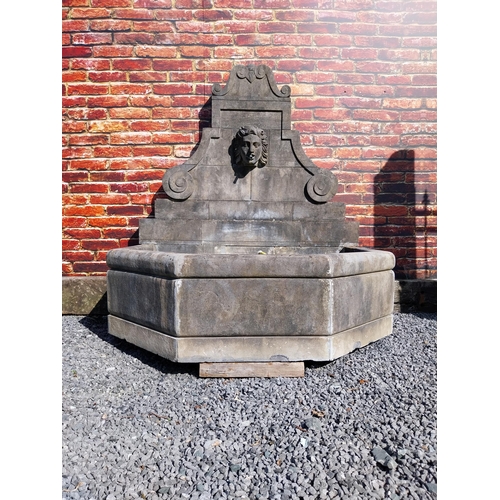 550 - Hand carved limestone wall fountain decorated with Ladies mask {172 cm H x 156 cm W x 127 cm D}.