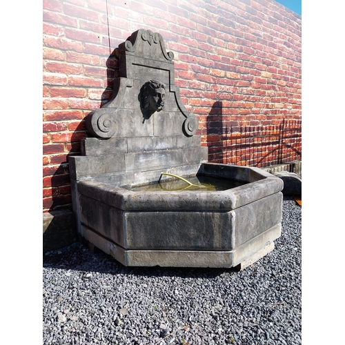 550 - Hand carved limestone wall fountain decorated with Ladies mask {172 cm H x 156 cm W x 127 cm D}.