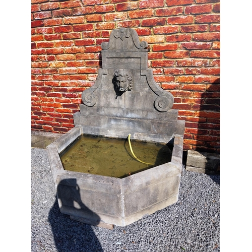 550 - Hand carved limestone wall fountain decorated with Ladies mask {172 cm H x 156 cm W x 127 cm D}.