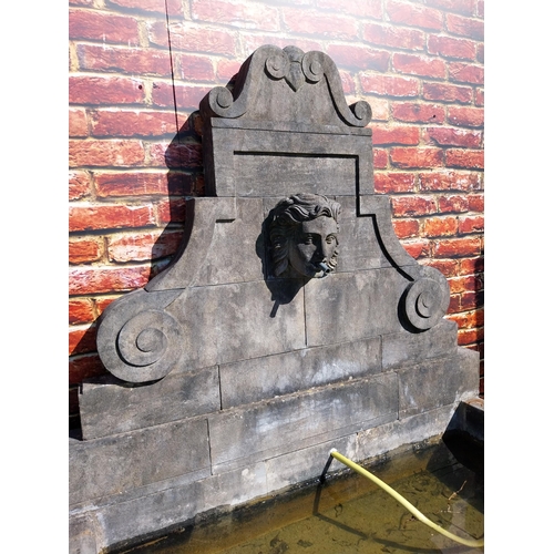 550 - Hand carved limestone wall fountain decorated with Ladies mask {172 cm H x 156 cm W x 127 cm D}.