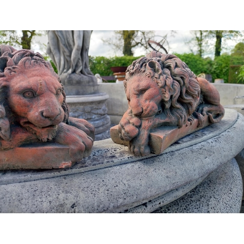 556 - Pair of moulded terracotta statuettes of recumbent Lions {14 cm H x 32 cm W x 11 cm D}.