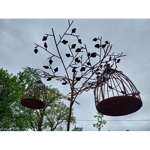 559 - Decorative wrought iron bird feeder in the form of a tree and two hanging bird cages {224 cm H x 135... 