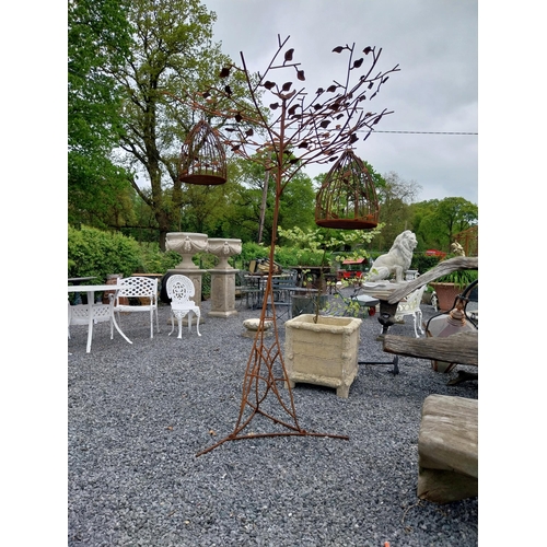 559 - Decorative wrought iron bird feeder in the form of a tree and two hanging bird cages {224 cm H x 135... 