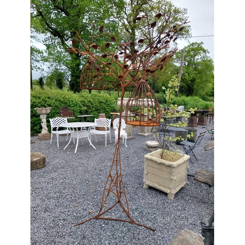 559 - Decorative wrought iron bird feeder in the form of a tree and two hanging bird cages {224 cm H x 135... 