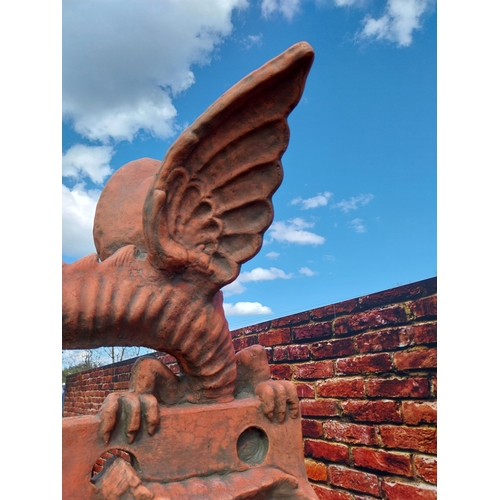 599 - Pair of moulded terracotta ridge tiles surmounted with Dragons {}.