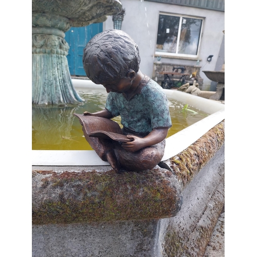 613 - Good quality bronze figure of a Boy reading {30 cm H x 24 cm W x 24 cm D}.