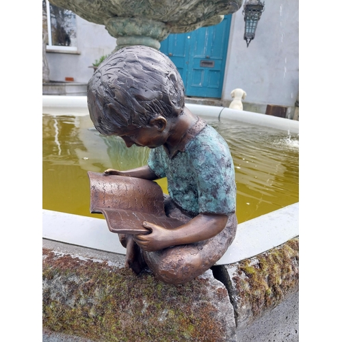 613 - Good quality bronze figure of a Boy reading {30 cm H x 24 cm W x 24 cm D}.