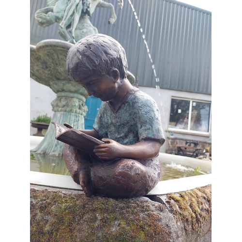 613 - Good quality bronze figure of a Boy reading {30 cm H x 24 cm W x 24 cm D}.