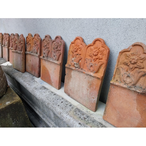 634 - Collection of seventeen early 20th C. terracotta edging tiles {25 cm H x 18 cm W each}.