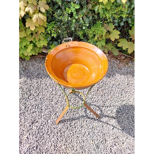 64 - Glazed terracotta bowl raised on metal stand {72 cm H x 52 cm Dia.}.